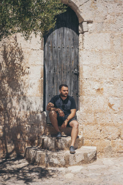 istock Vertical shot of man sitting on a stone stair 1459915009