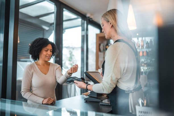 istock Hispanic Female Using Smart Watch As A Payment Method In A Cafe 1459915050