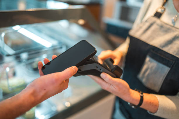 istock Caucasian Male Paying With Smartphone In A Cafe 1459915116