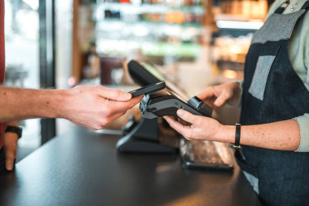 istock Caucasian Male Paying With Smartphone In A Cafe 1459915133
