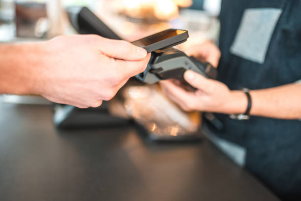 istock Caucasian Male Paying With Smartphone In A Cafe 1459915174
