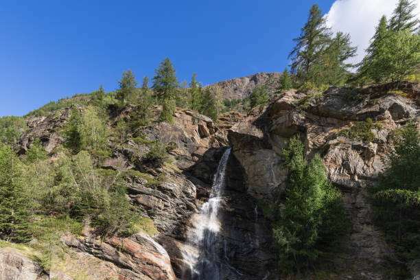 istock Centuries-old granite karst rocks have formed crevice in rock along which silvery streams of Lillaz waterfall (Cascate di Lillaz) Aosta valley, Italy 1459915198