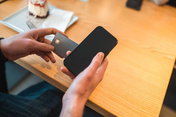 istock Caucasian Male Using Smartphone In A Cafe 1459915322