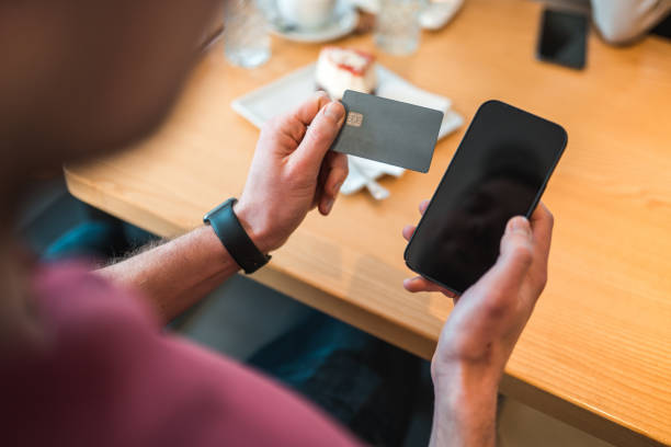 istock Caucasian Male Using Smartphone In A Cafe 1459915367