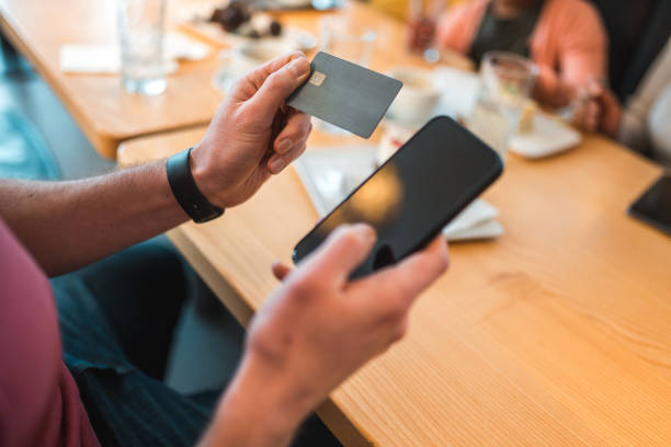 istock Caucasian Male Using Smartphone In A Cafe 1459915418