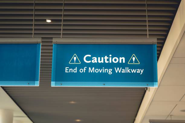 istock Hanging blue cation sign warning the end of a moving walkway 1459915502