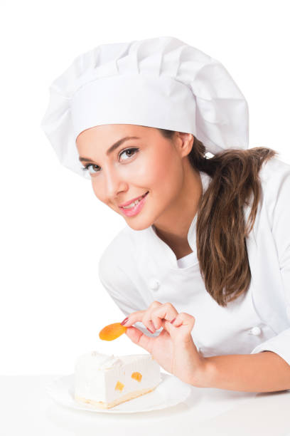 Gorgeous young brunette chef woman isolated on white background.