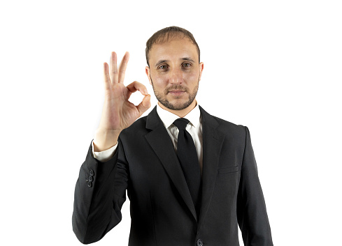 A Caucasian man showing the OK gesture with his right hand on a white background
