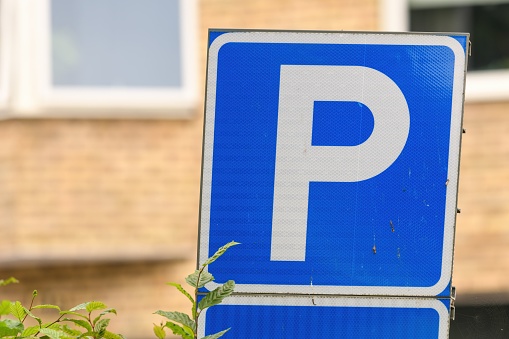a closeup of a blue parking sign