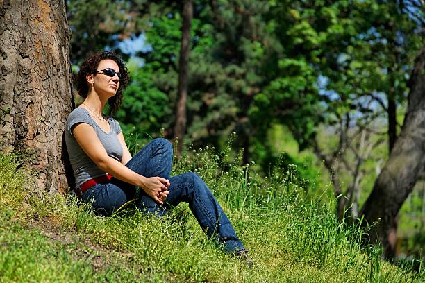 young women relaxes in the green stock photo