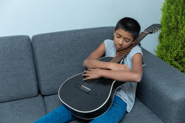 istock Hispanic male child taking a nap after a guitar lesson 1459919070