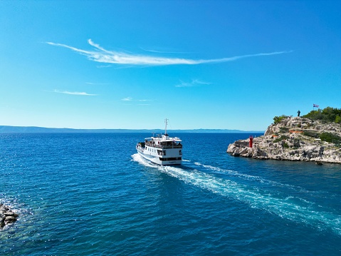 Ferry leaving Makarska town Croatia Dalmatian coast drone aerial view