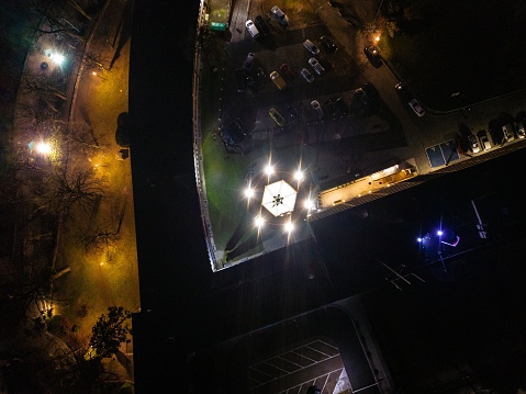 An aerial view of the illuminated Piast Tower in the evening in Opole, Poland