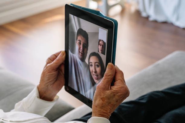 istock Elderly woman using a tablet to see her grandchildren during covid confinement 1459922480