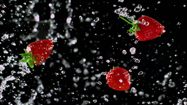 Strawberry and Water Rotation on Black Background - Super Slow Motion