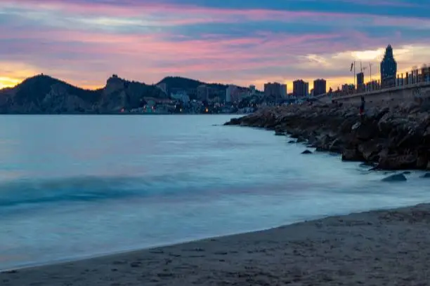 Photo of Sunset with many and different colors of the city of Benidorm in Alicante with the sea at a very low