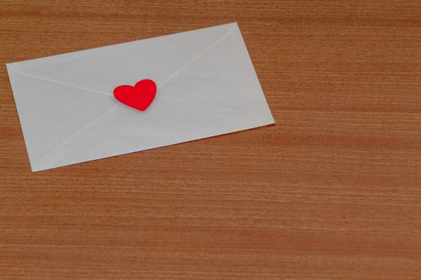 istock Love letter for Valentine's Day inside a white envelope closed and sealed with a red heart on a wood 1459924286