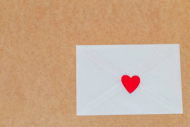 istock Love letter for Valentine's Day inside a white envelope closed and sealed with a red heart on a wood 1459924288