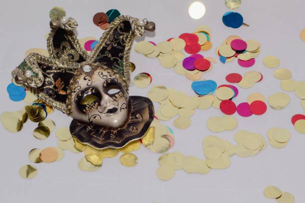 Venetian mask on a white Carnival-themed background with colored confetti.