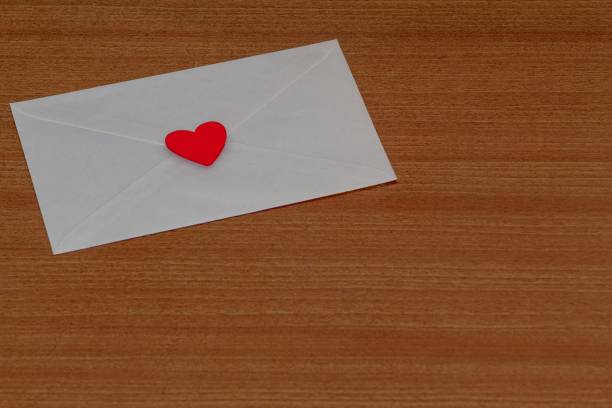 istock Love letter for Valentine's Day inside a white envelope closed and sealed with a red heart on a wood 1459924369