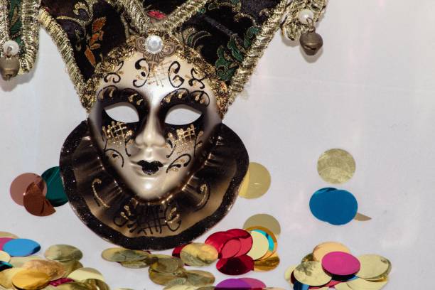 istock Venetian mask on a white Carnival-themed background with colored confetti . 1459924382