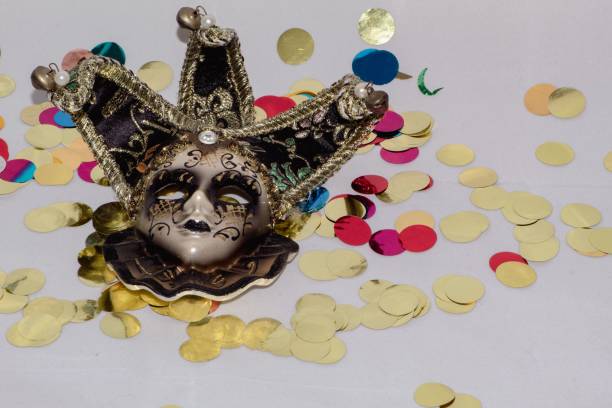 istock Venetian mask on a white Carnival-themed background with colored confetti. 1459924385