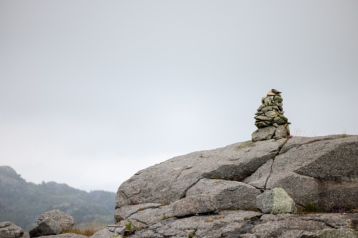 A stack of rocks standing in balance on top of a cliff, the concept of zen philosophy