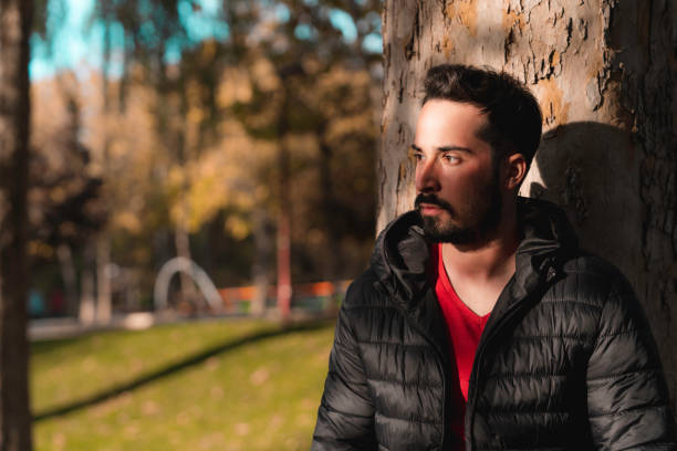 istock Shallow focus of a young man standing under a tree in the shadow 1459925704