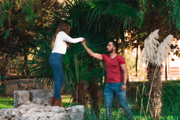 A young couple outdoors in a green park