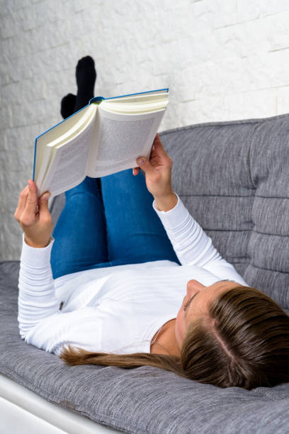 istock Girl reads a book and relaxes 1459926618