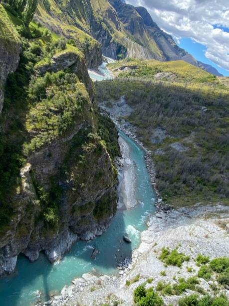 istock Vertical top view of a river with blue water and surrounded by rocks. 1459927147