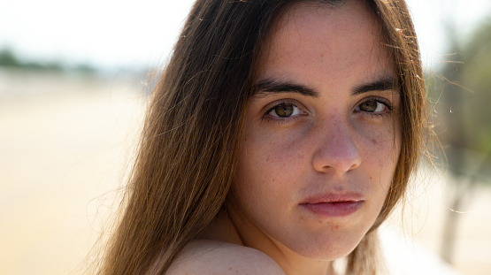 A shallow focus portrait of a young attractive female looking into the camera