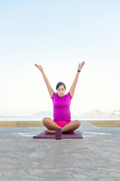Caucasian woman doing exercise beside a pool