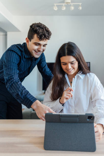 istock Cheerful Caucasian friends working together at home 1459930016