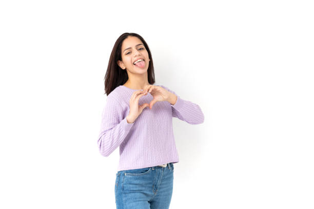 istock Latin woman making heart shape with her hands on white background 1459930521