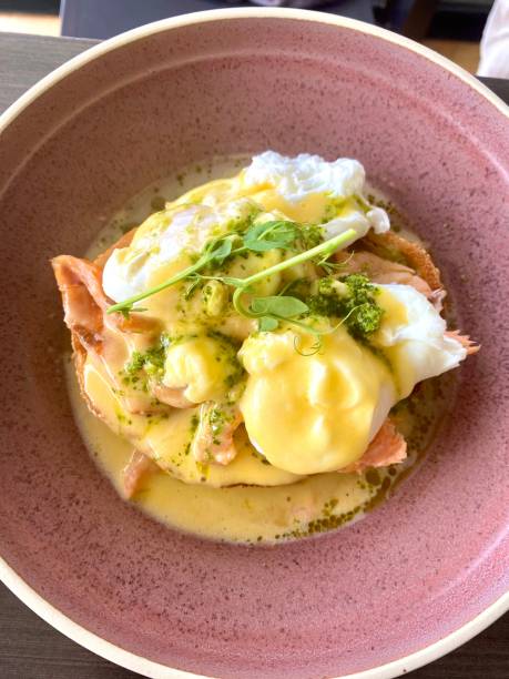 istock Vertical close-up shot of eggs benedict with salmon in a bowl 1459930870
