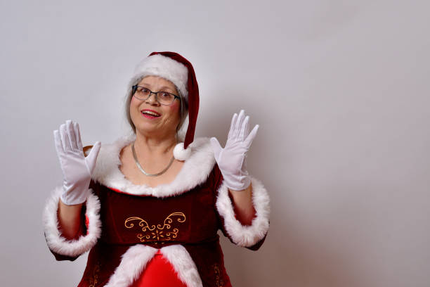 istock American female Claus with a bright smile and raised hands 1459930992