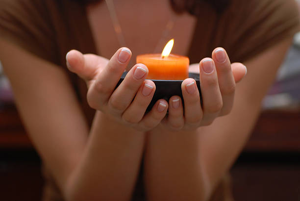 istock Relaxing young woman with a candle 145993141