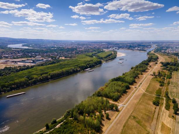 istock Aerial view of a river with with lush green vegetation and fields on both sides 1459931572