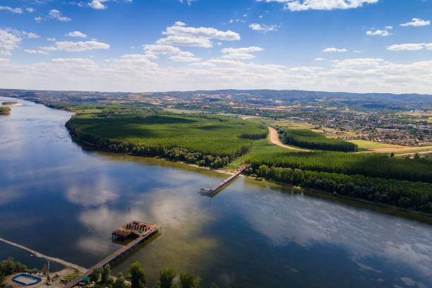 istock Aerial view of a river with with lush green vegetation and fields on both sides 1459931576