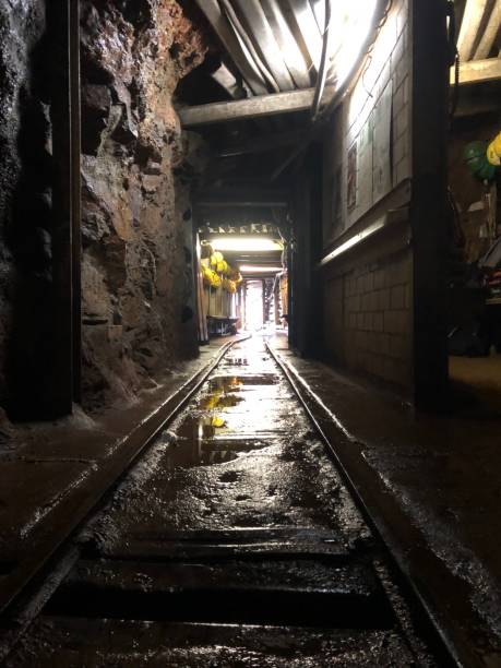 istock Inside view of the underground tunnel of coal mining with lights around 1459932092
