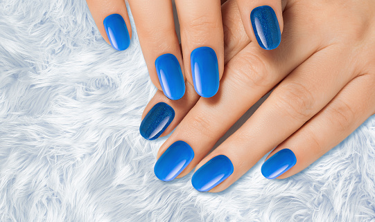 Blue manicure on female hands. Nails design.