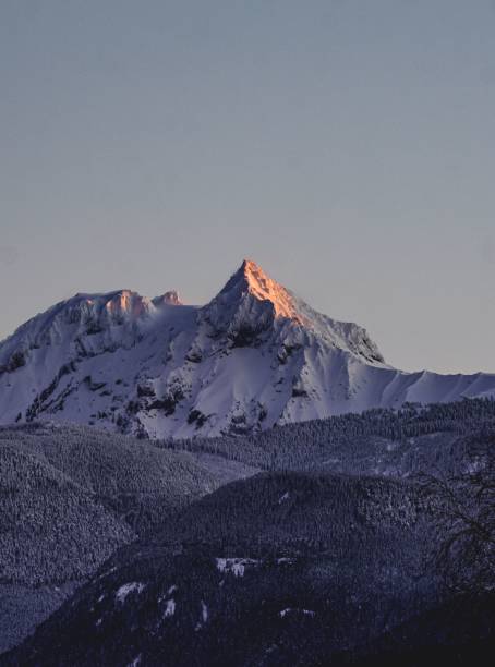 istock Vertical shot of a snow-covered mountain peak during sunrise 1459933001