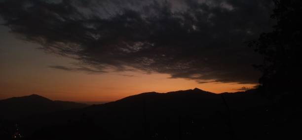istock Panoramic shot of a bright sunset sky over beautiful mountains 1459933346
