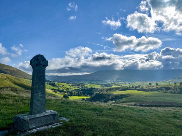 istock Grave with the Celtic cross monument in the field under a blu sky 1459934137