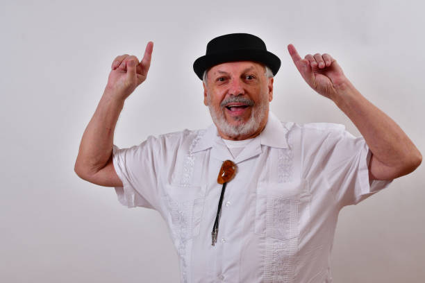 istock Happy elderly gentleman smiling and pointing up with both index fingers 1459934762