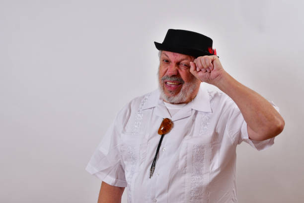 istock View of an elderly man in a hat scratching his head trying to remember on a white background 1459935178