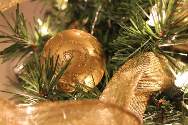 istock Closeup of pine tree with golden Christmas ball 1459935821