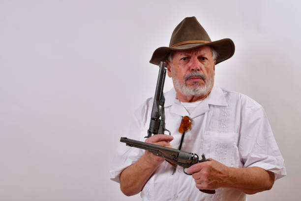 istock Angry senior man aiming two revolvers 1459935825