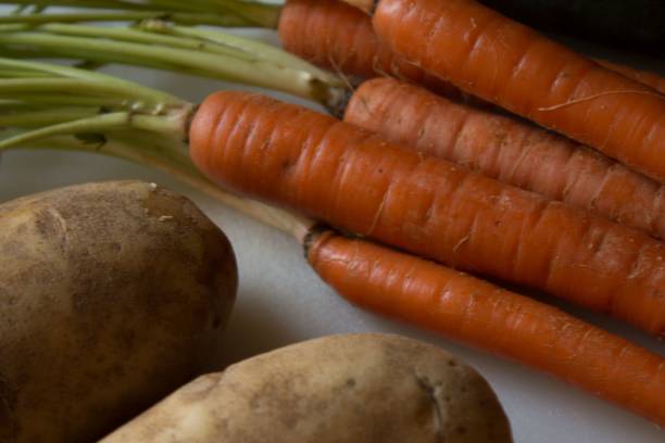 istock Closeup of carrots and potatoes 1459935838